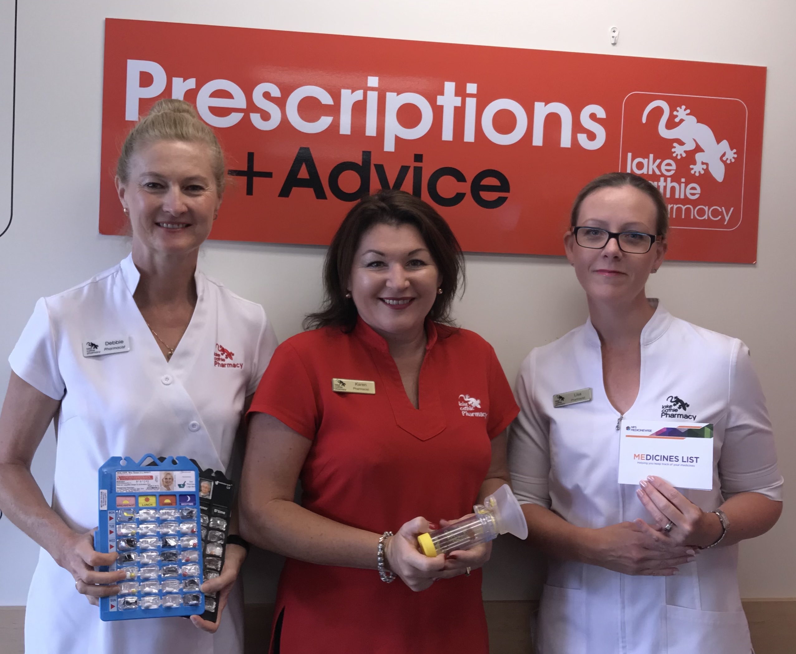 Pharmacy team with medicine packs and a medicines list
